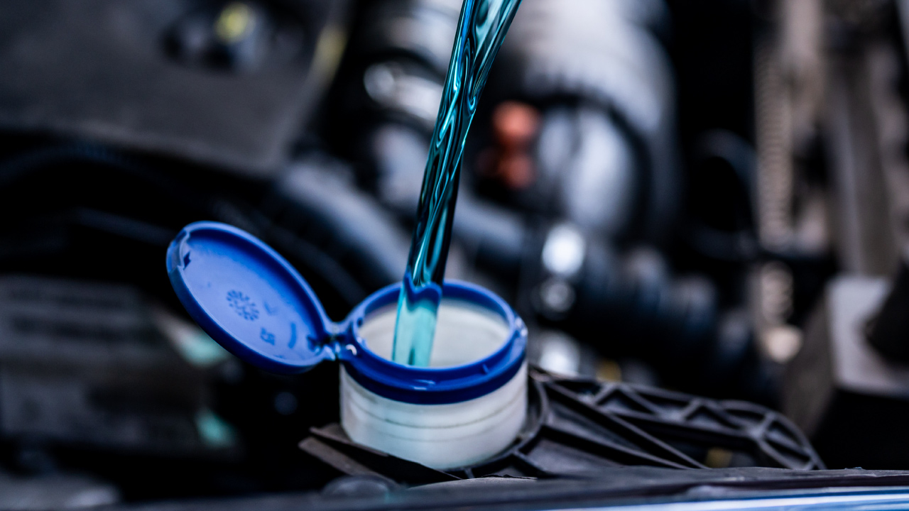 car coolant being poured into the reservoir