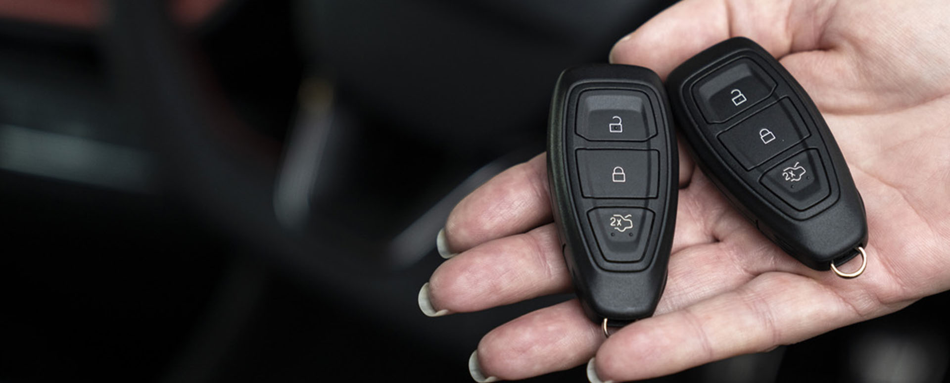 Car key fob, resting on someone's hand