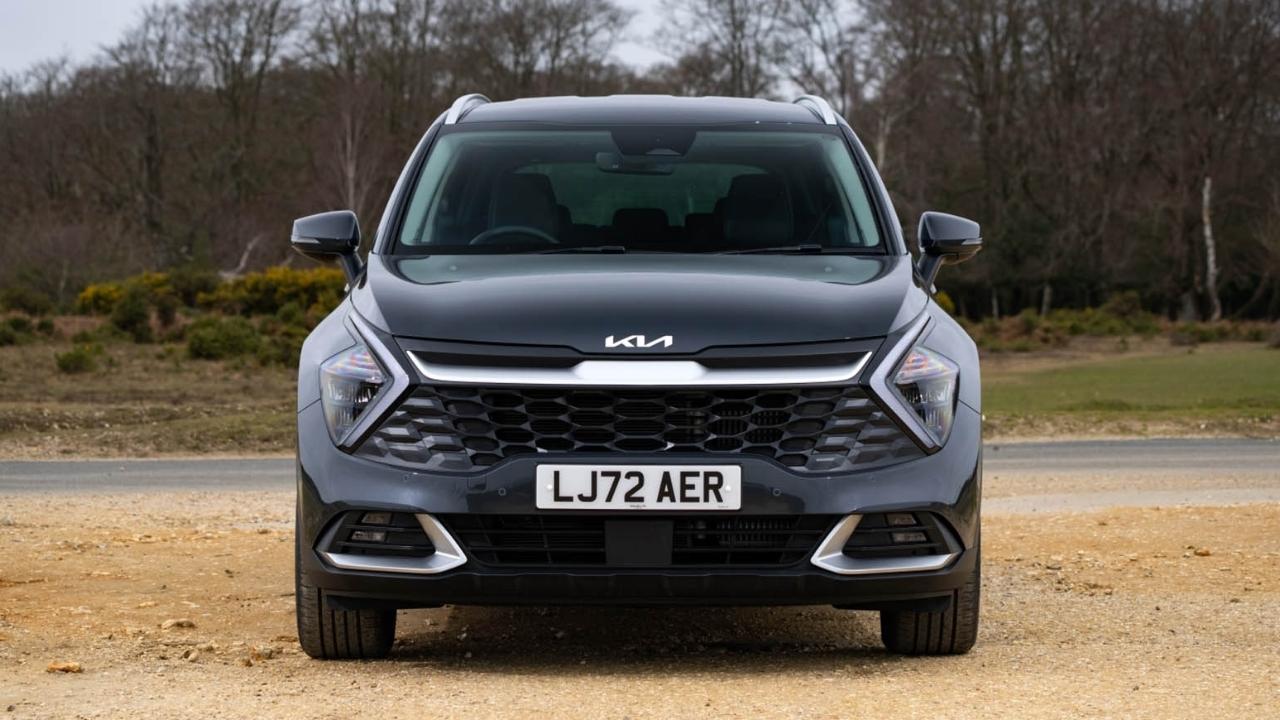 Black Kia Sportage parked on the side of the road