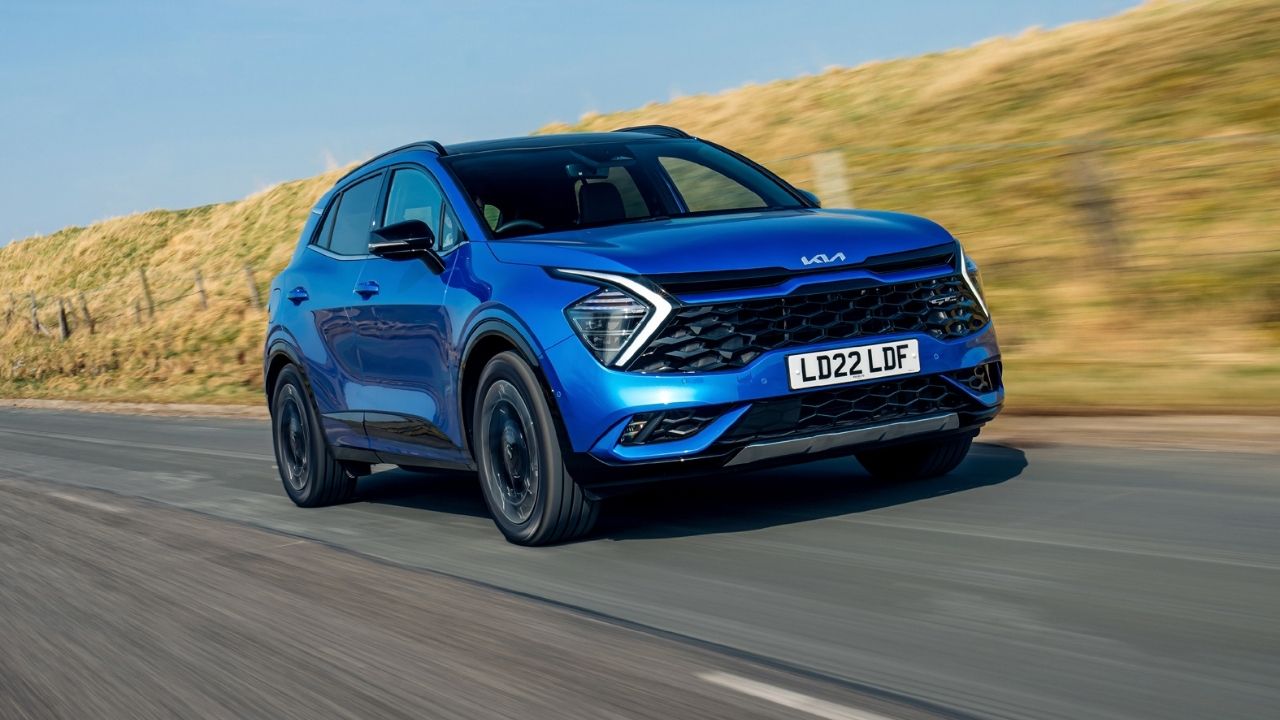 Blue Kia Sportage driving on a motorway