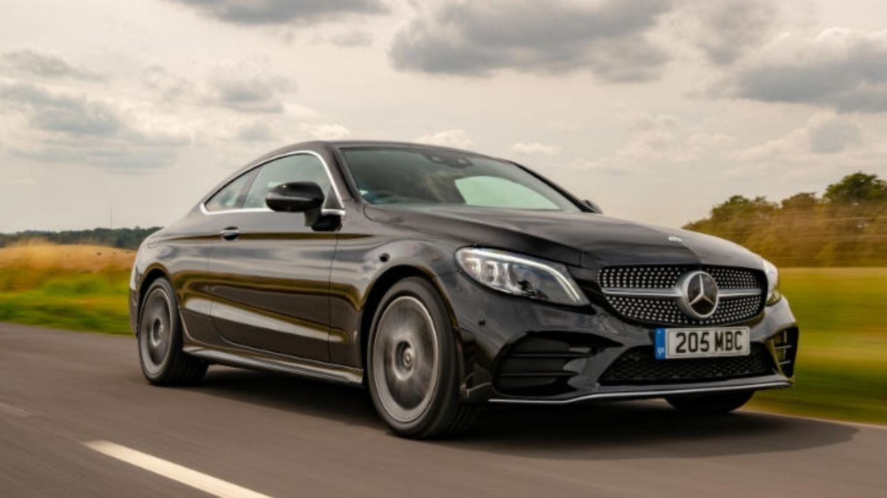 Black Mercedes-Benz C-Class driving in the countryside