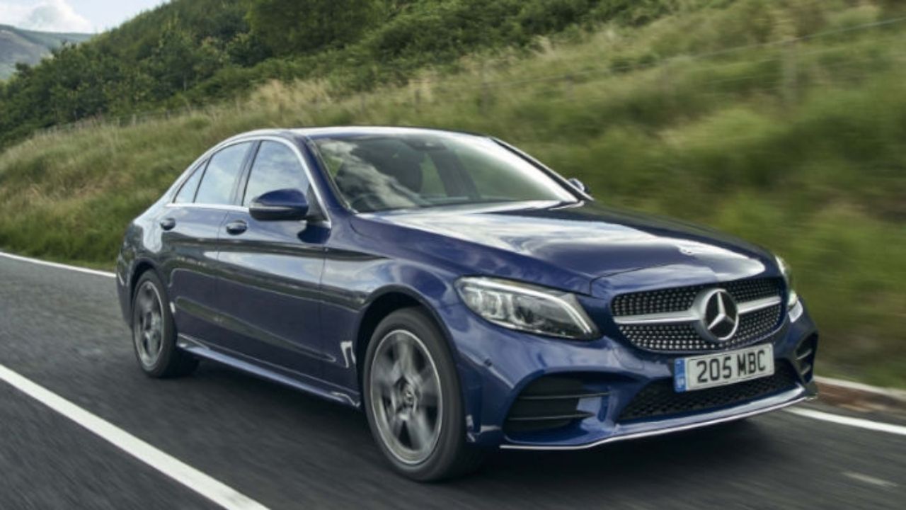 Blue Mercedes-Benz C-Class driving in the countryside
