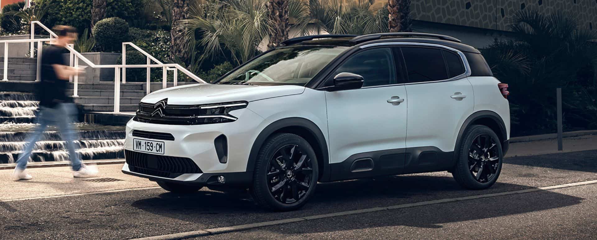 White Citroen C5 Aircross parked in front of stairs in the street