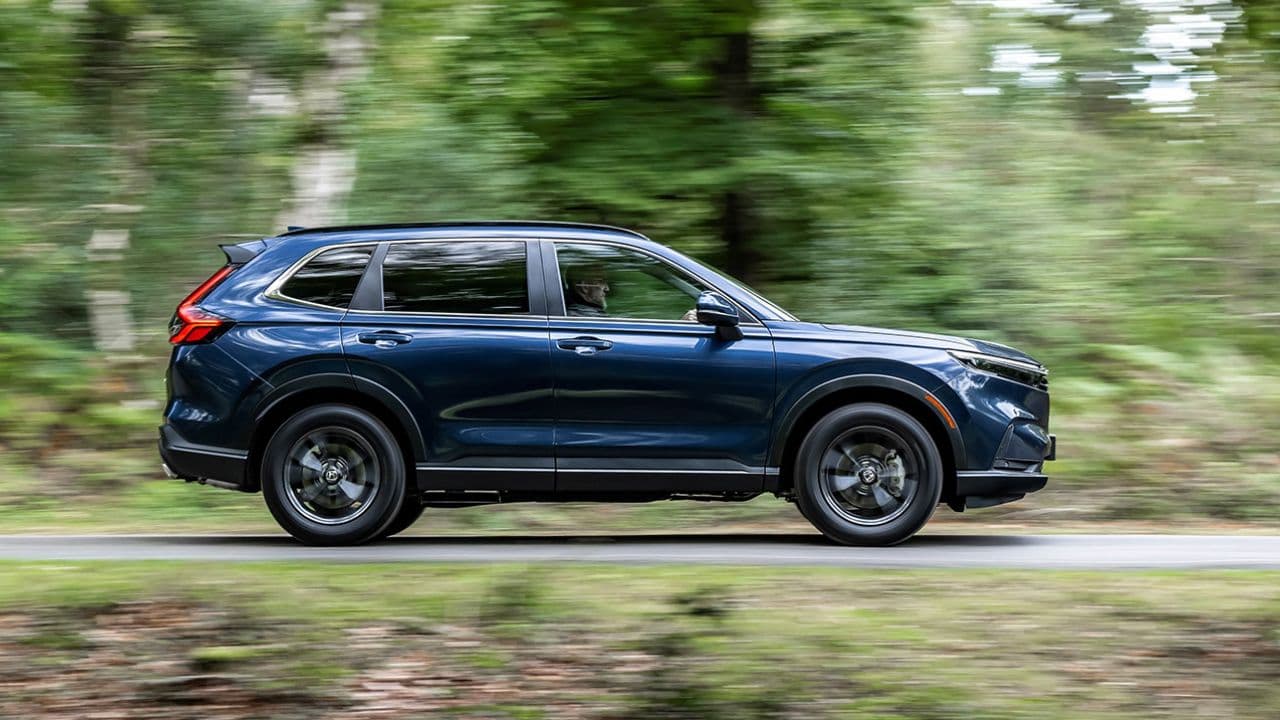 Blue Honda CR-V driving in the countryside