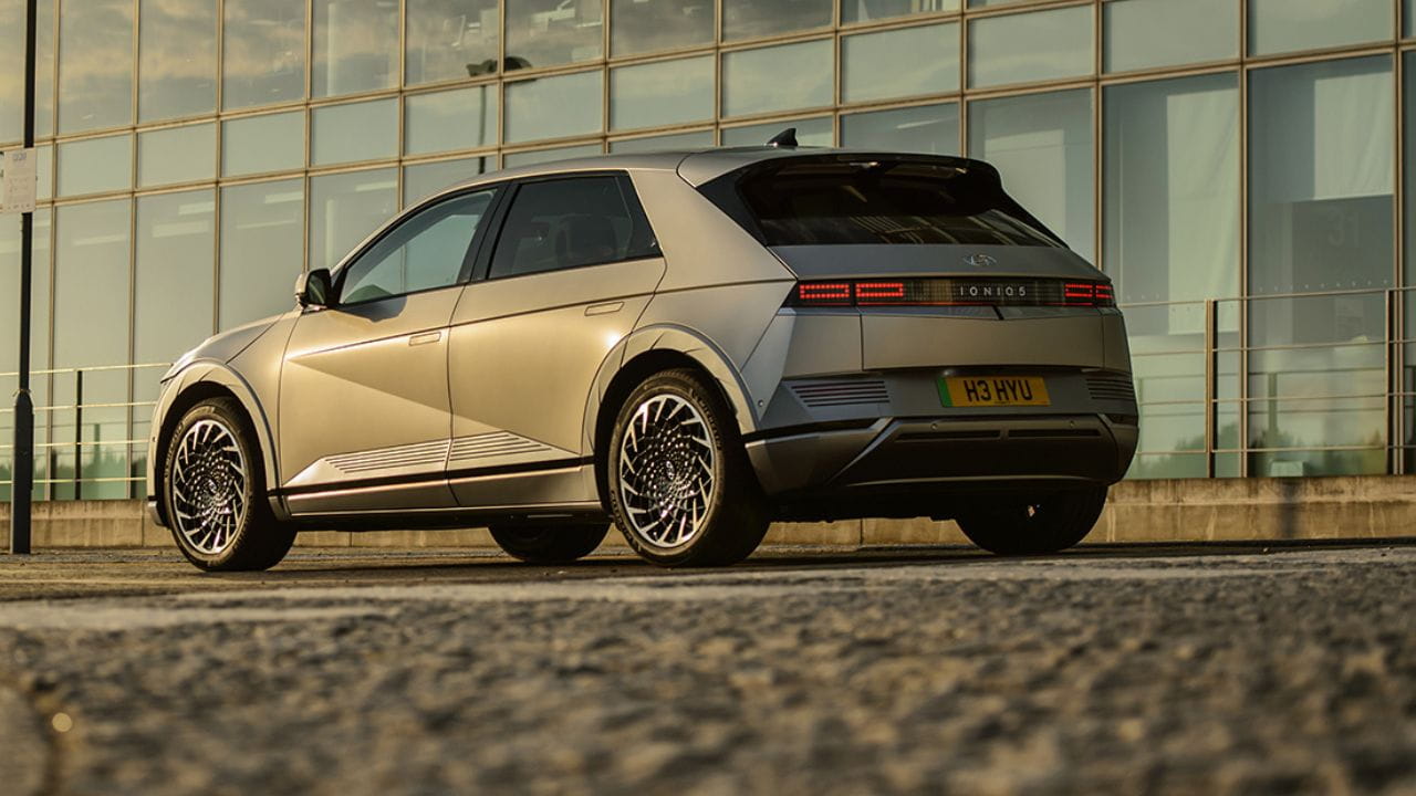 Hyundai IONIQ 5 parked in front of a glass building