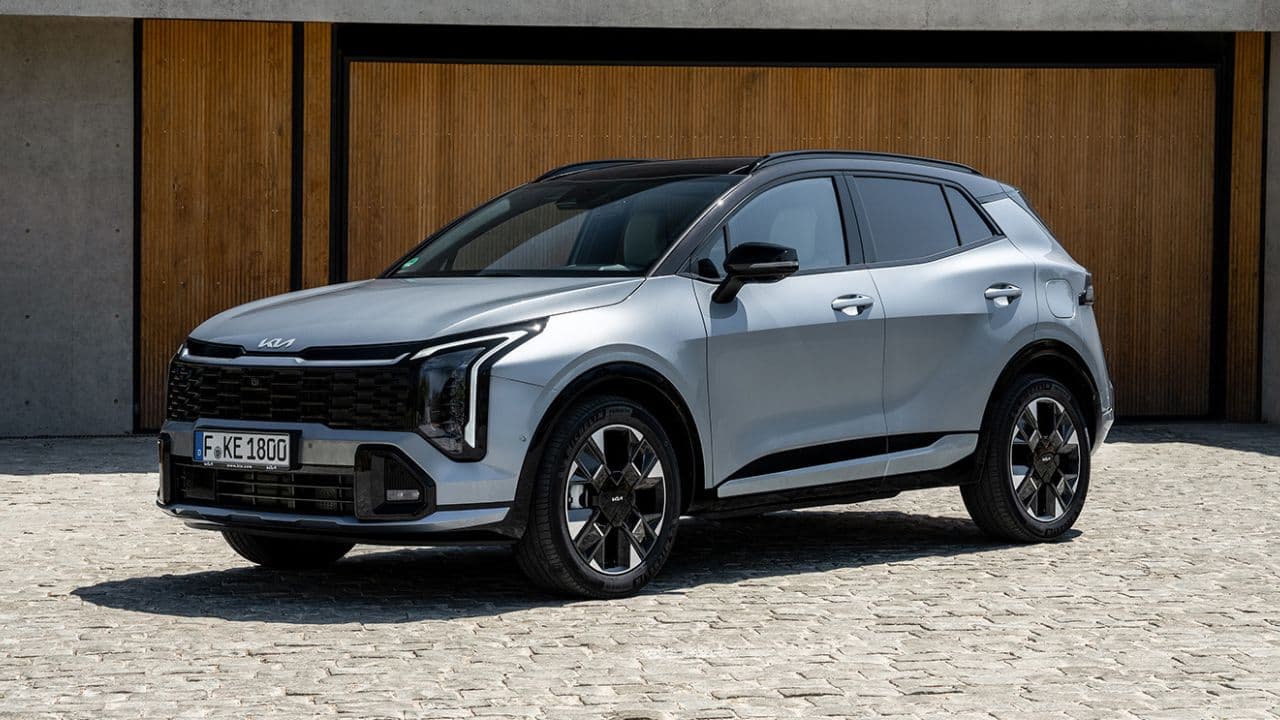 Kia Sportage parked in front of wooden garage doors