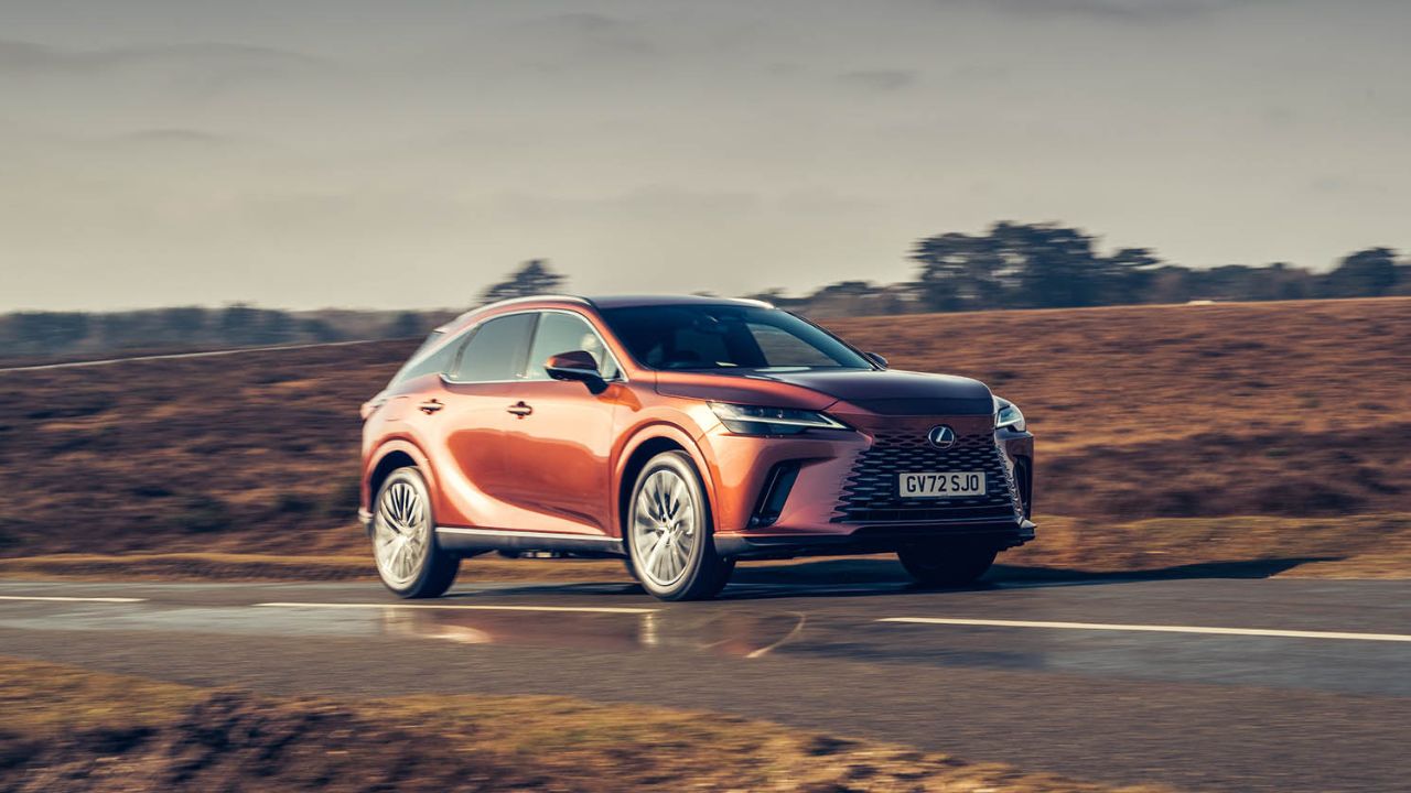 Orange Lexus XR driving in the countryside
