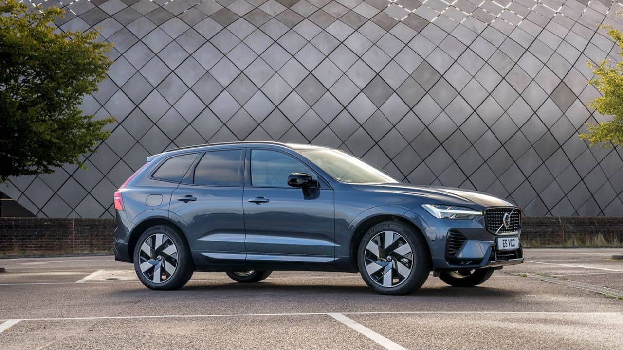 Blue Volvo XC60 parked in front of a silver monument