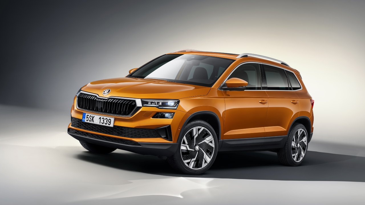 Orange Škoda Karoq SUV in a studio setting highlighting its exterior design
