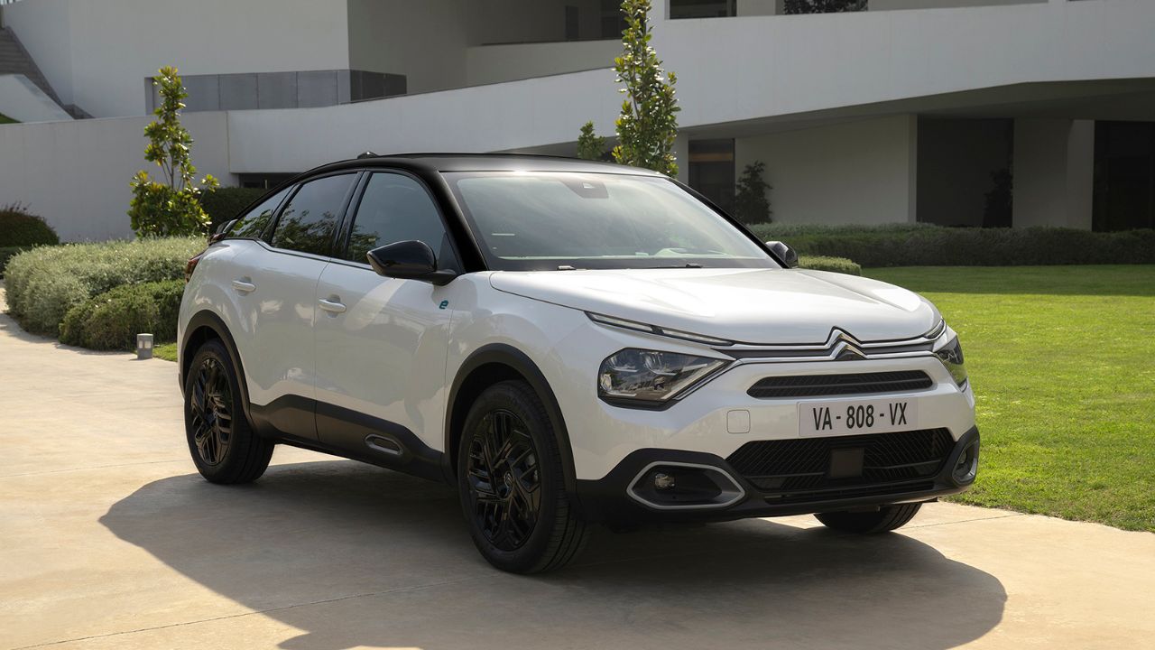 White Citroen C4 parked in front of a modern looking house