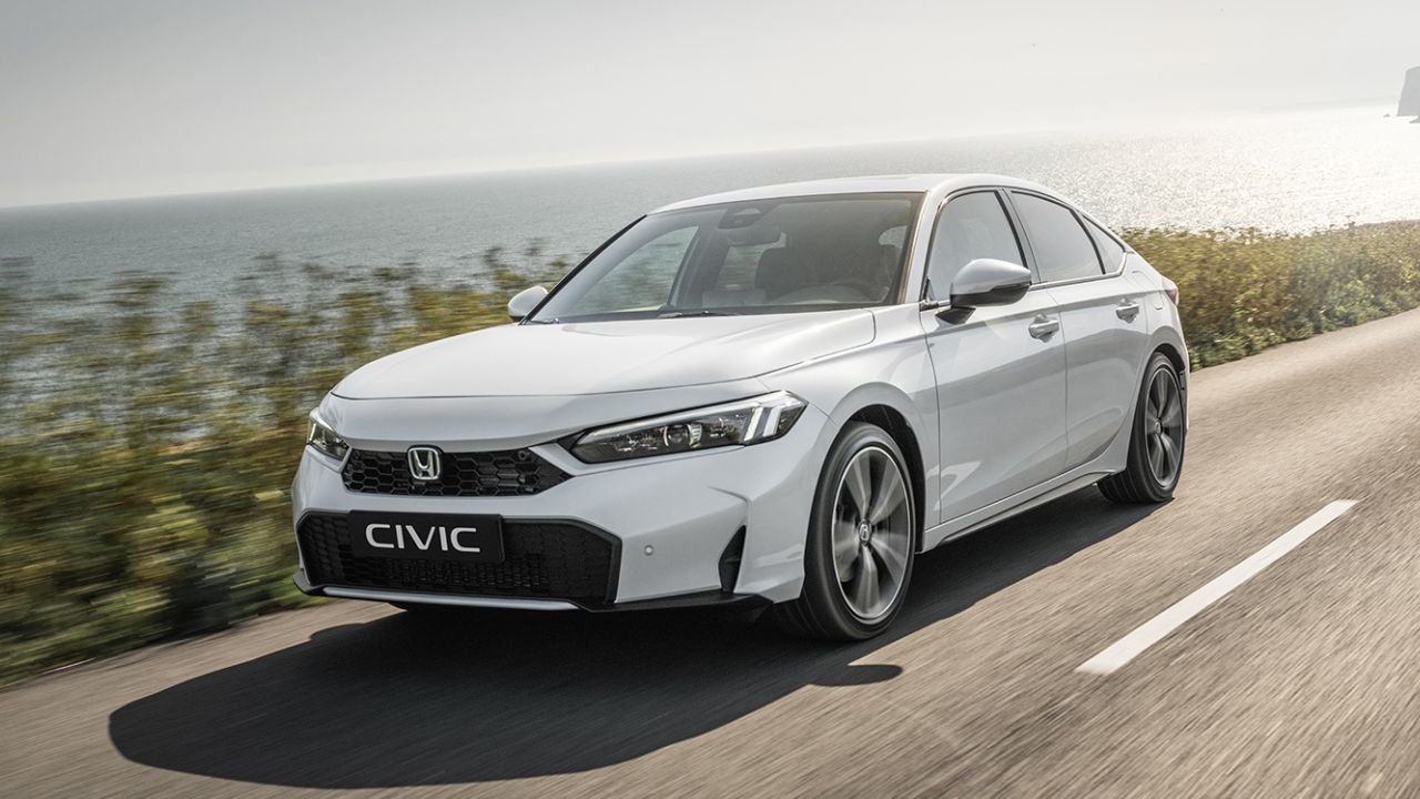 White Honda Civic driving on the motorway by the seaside