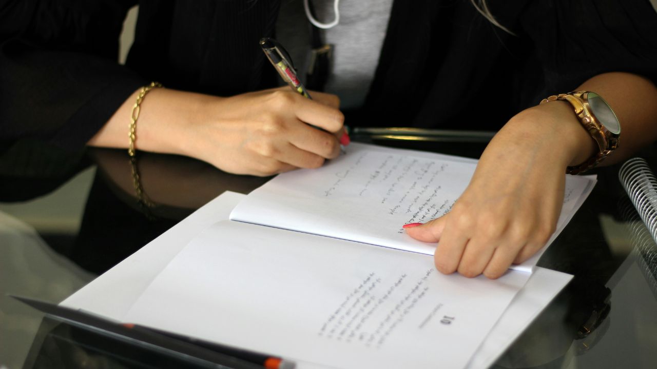 Woman signing a contract