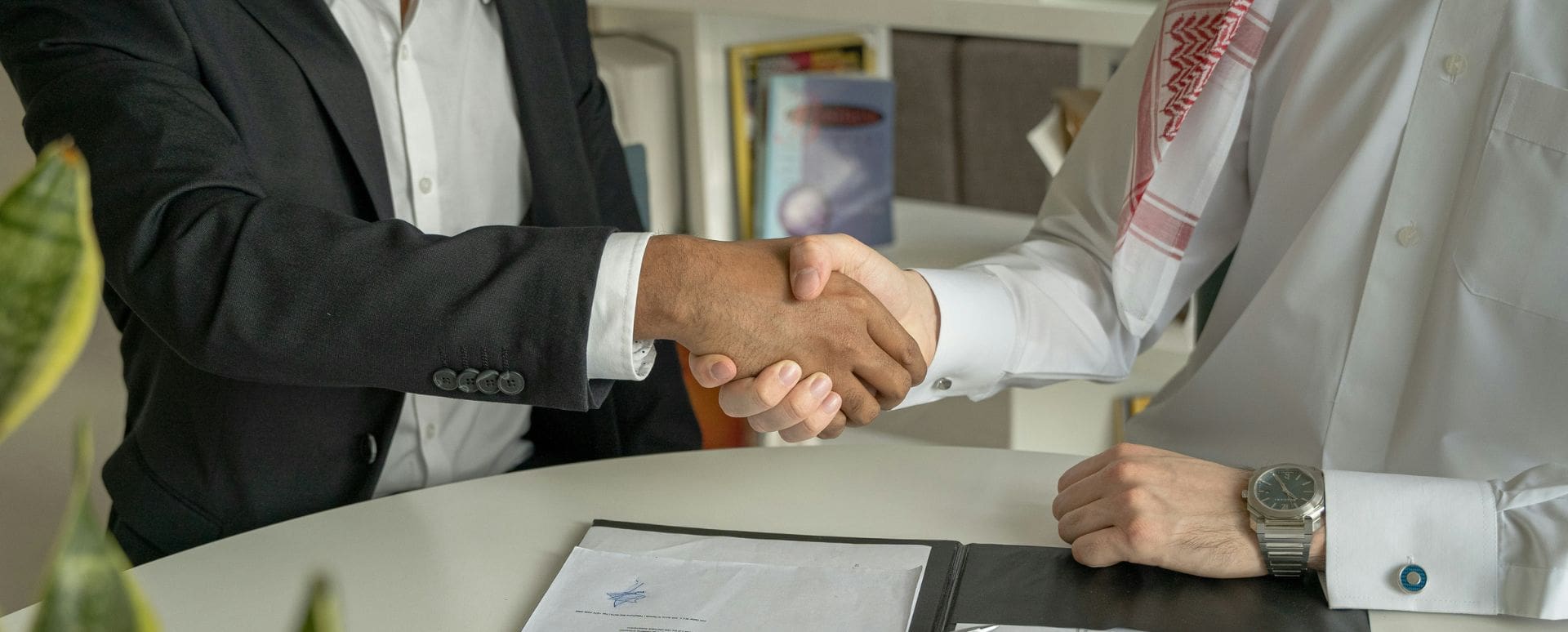 Two men shaking hands upon the closure of a deal