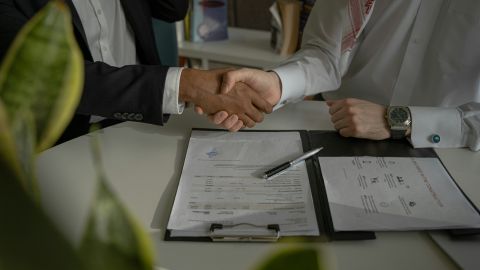 Two men shaking hands upon the closure of a deal