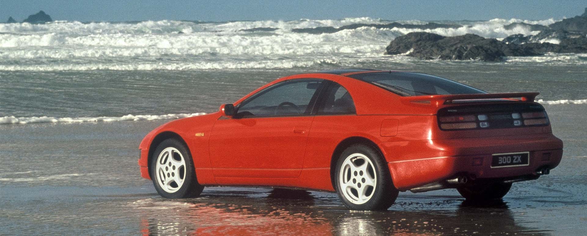 Red Nissan 300ZX rear quarter shot, parked on a beach