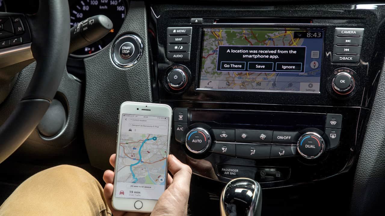 Nissan Dashboard Controls And Phone In Hand