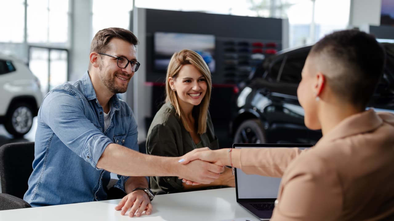 Man and woman shacking hands to close deal