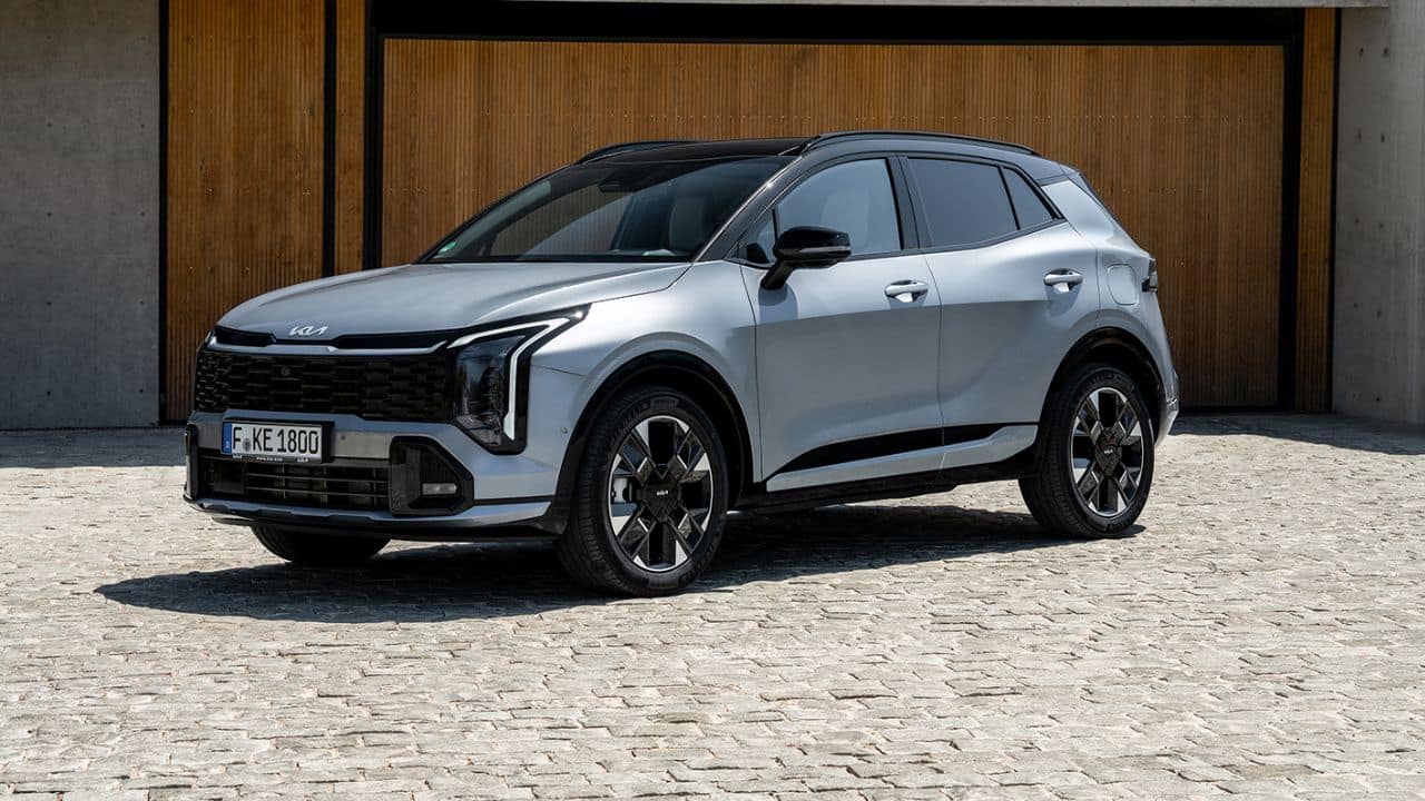 Silver Kia Sportage parked in front of a wooden door