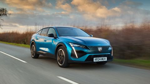 Blue Peugeot 308 driving on the motorway