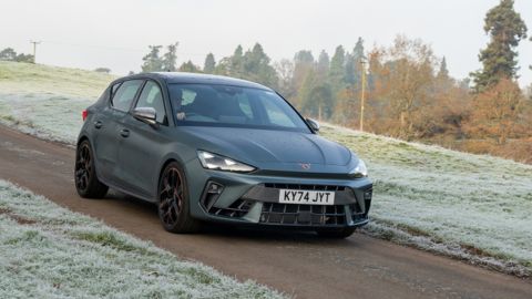 Black SEAT Leon driving in the countryside