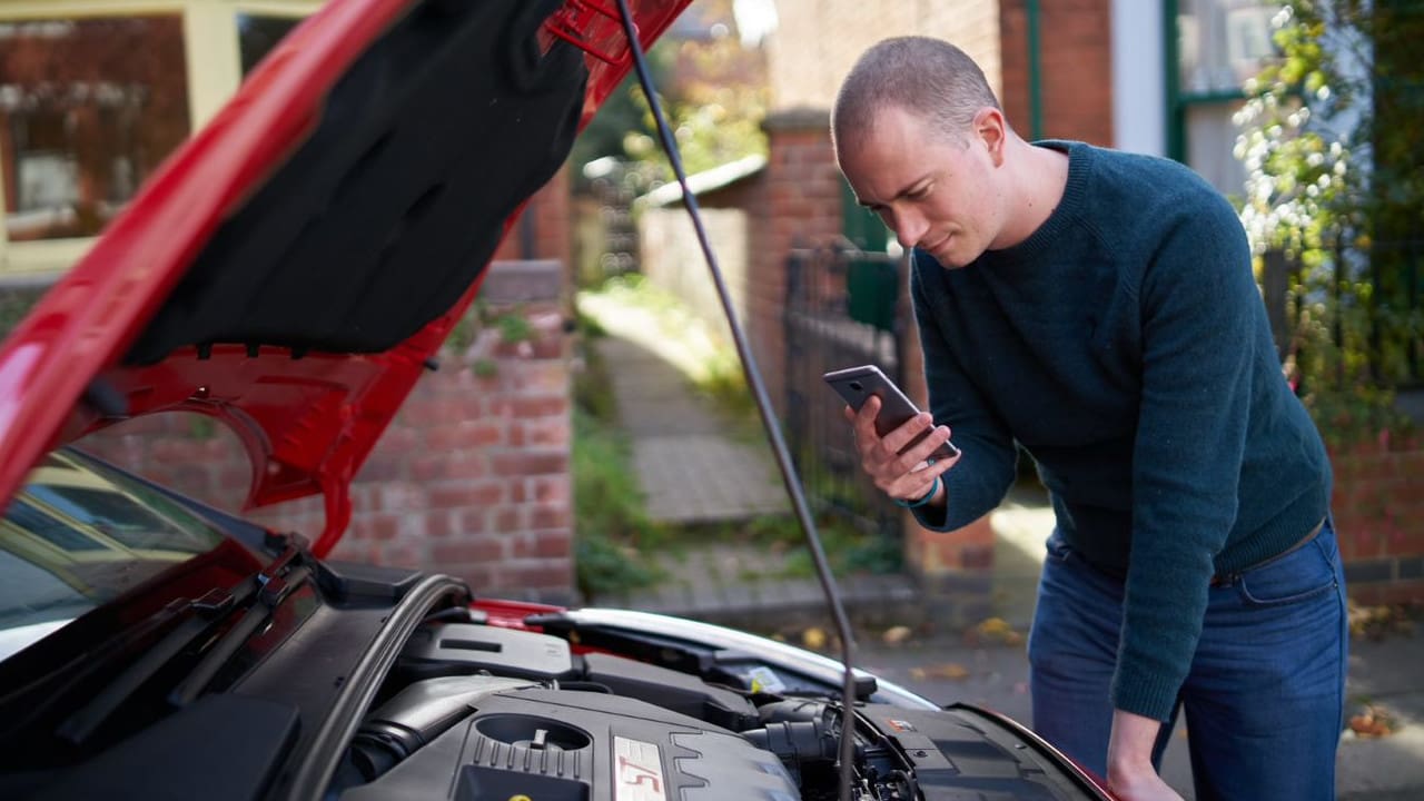 Man Inspecting Car