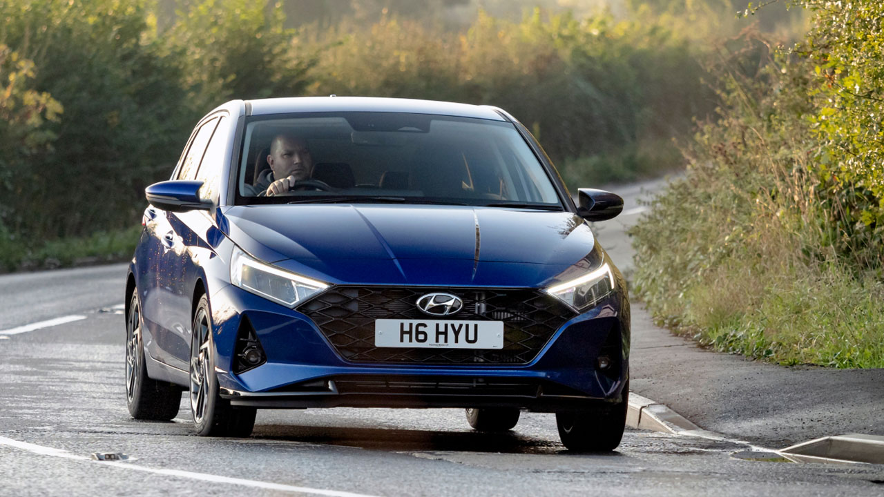 Blue Hyundai i20, driving