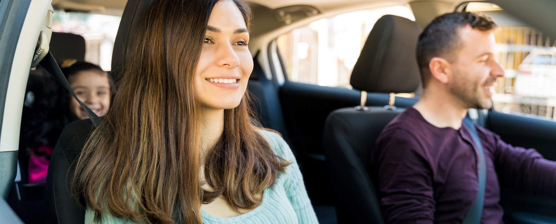 Parents and Young Child Sitting in Car