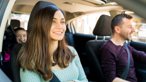 Parents and Young Child Sitting in Car