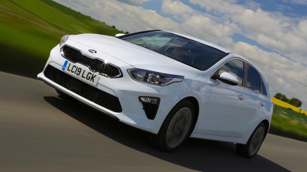 White Kia Ceed, driving