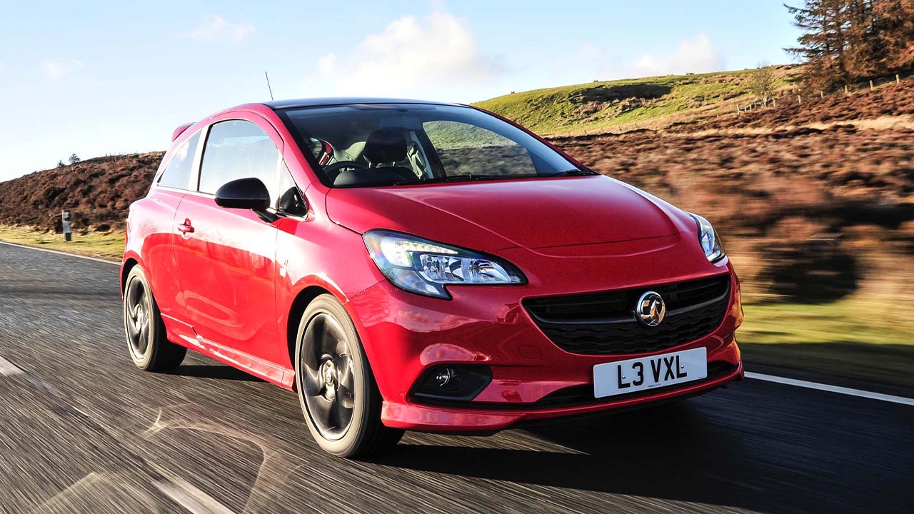 Red Vauxhall Corsa, driving
