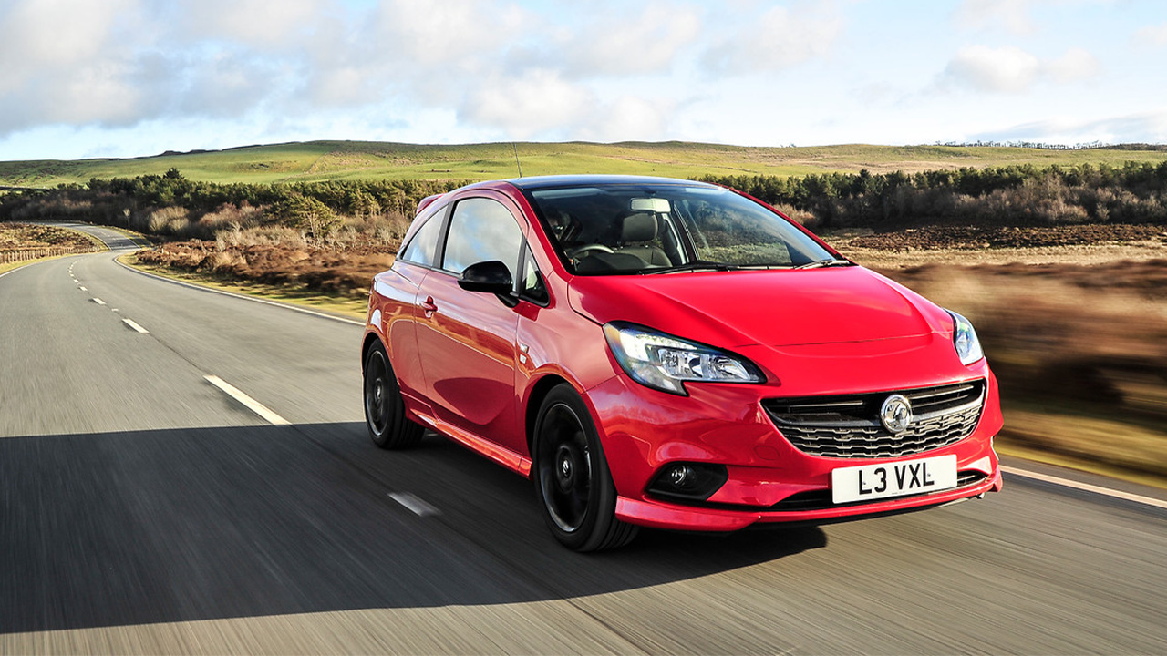 Red Vauxhall Corsa, driving