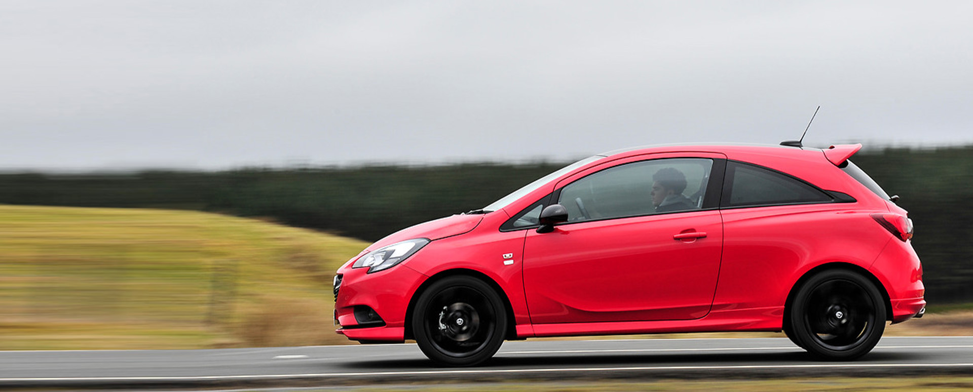 Red Vauxhall Corsa, driving