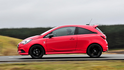 Red Vauxhall Corsa, driving