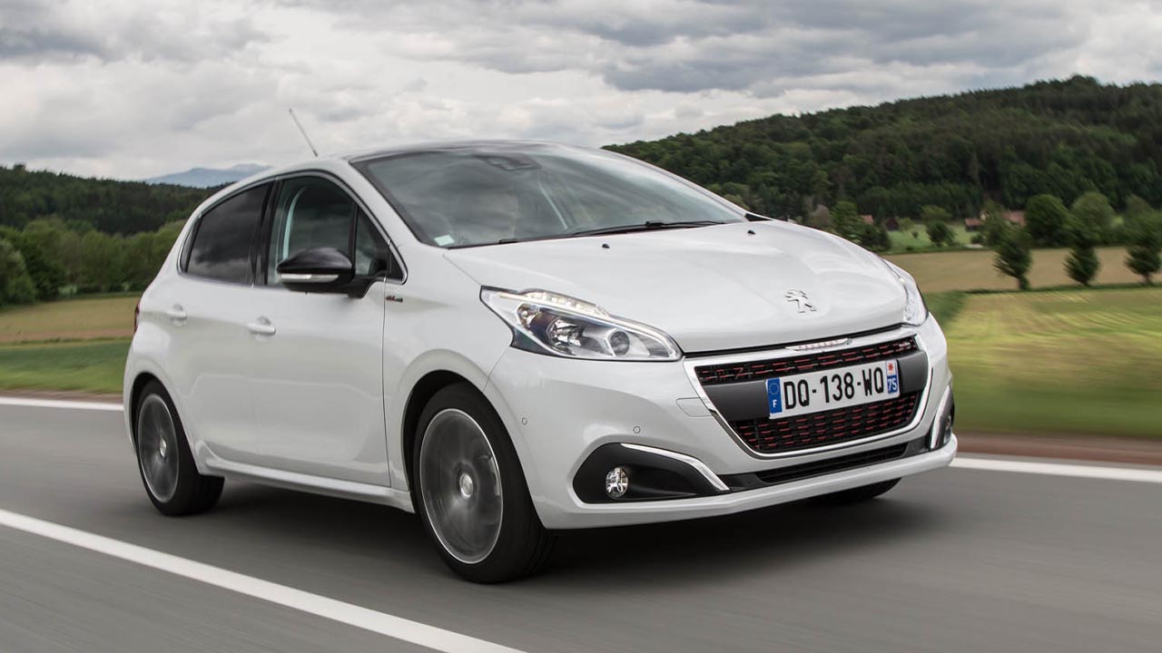 White Peugeot 208, driving