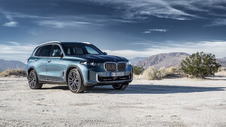 Blue BMW X5 front right mountain range