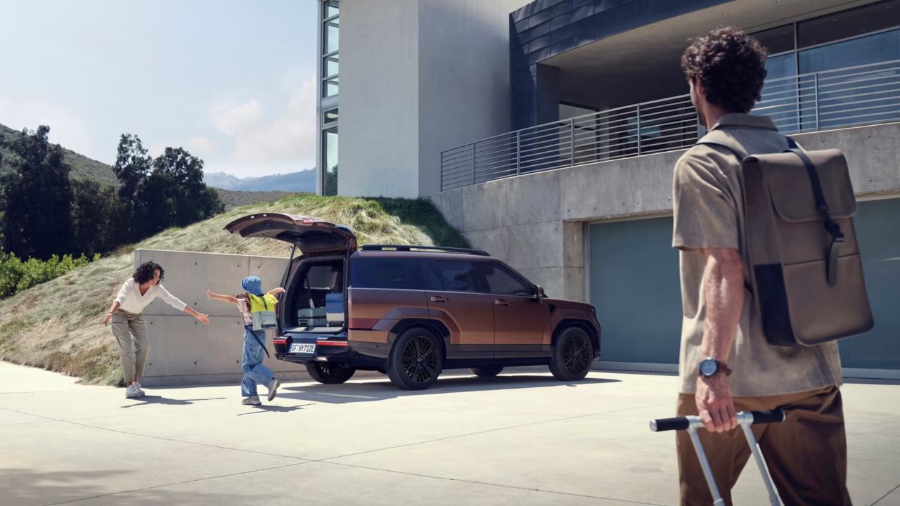 Brown Hyundai Santa Fe with family playing