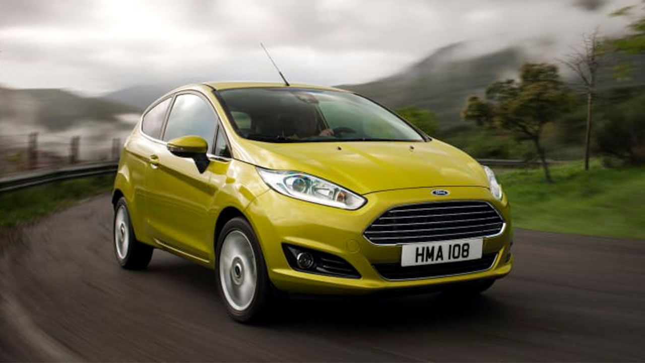 Yellow Ford Fiesta, driving