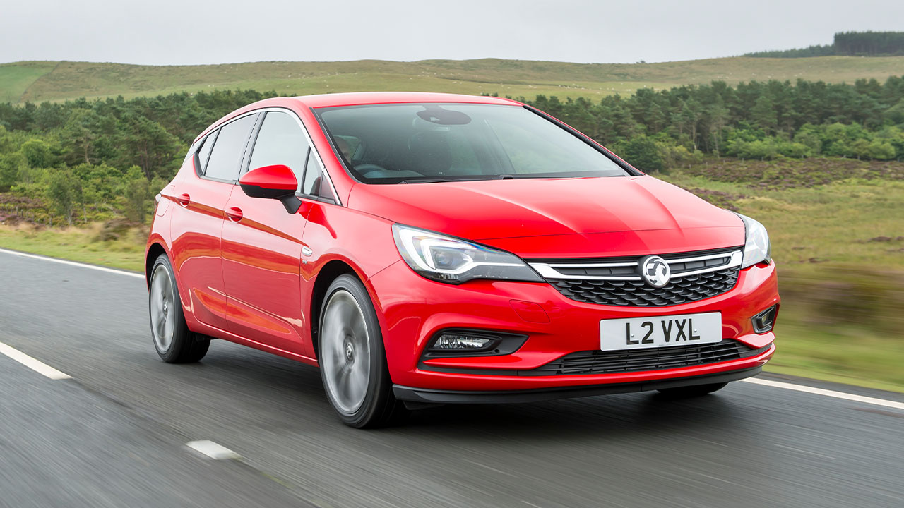 Red Vauxhall Astra, driving in countryside