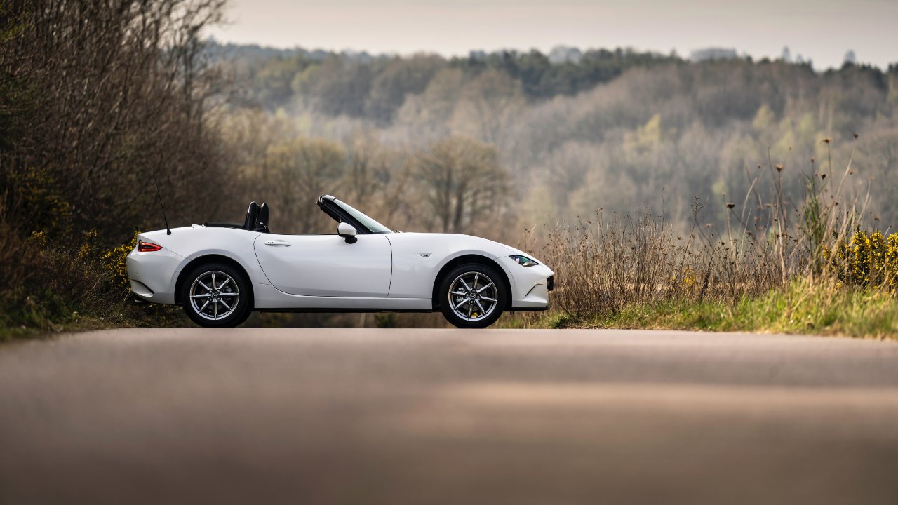 Mazda MX-5 white side with roof down