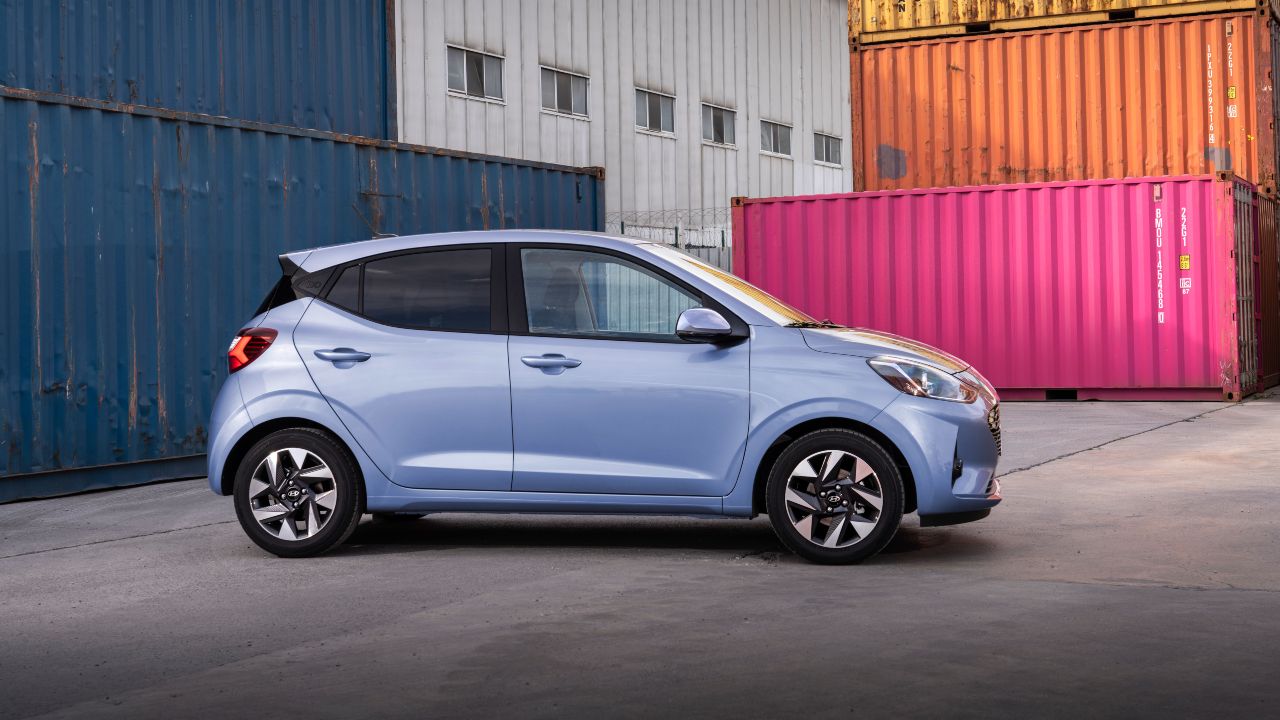 Blue Hyundai i10 side with shipping containers behind