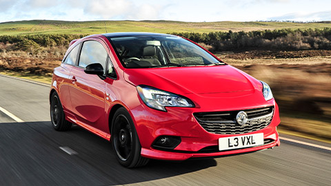 Red Vauxhall Corsa, driving in countryside