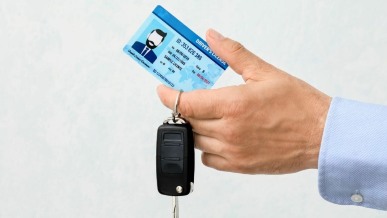Driving Licence Photocard in Hand with Car Keys