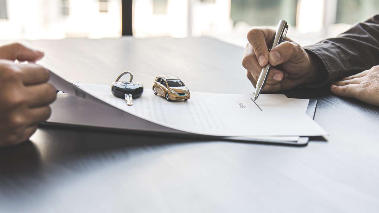 Man signing a contract on a table