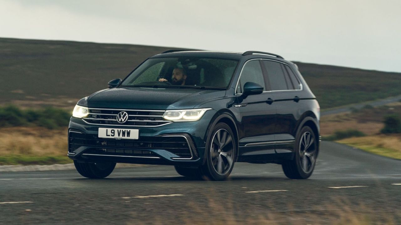 Dark blue Volkswagen Tiguan driving in the country side