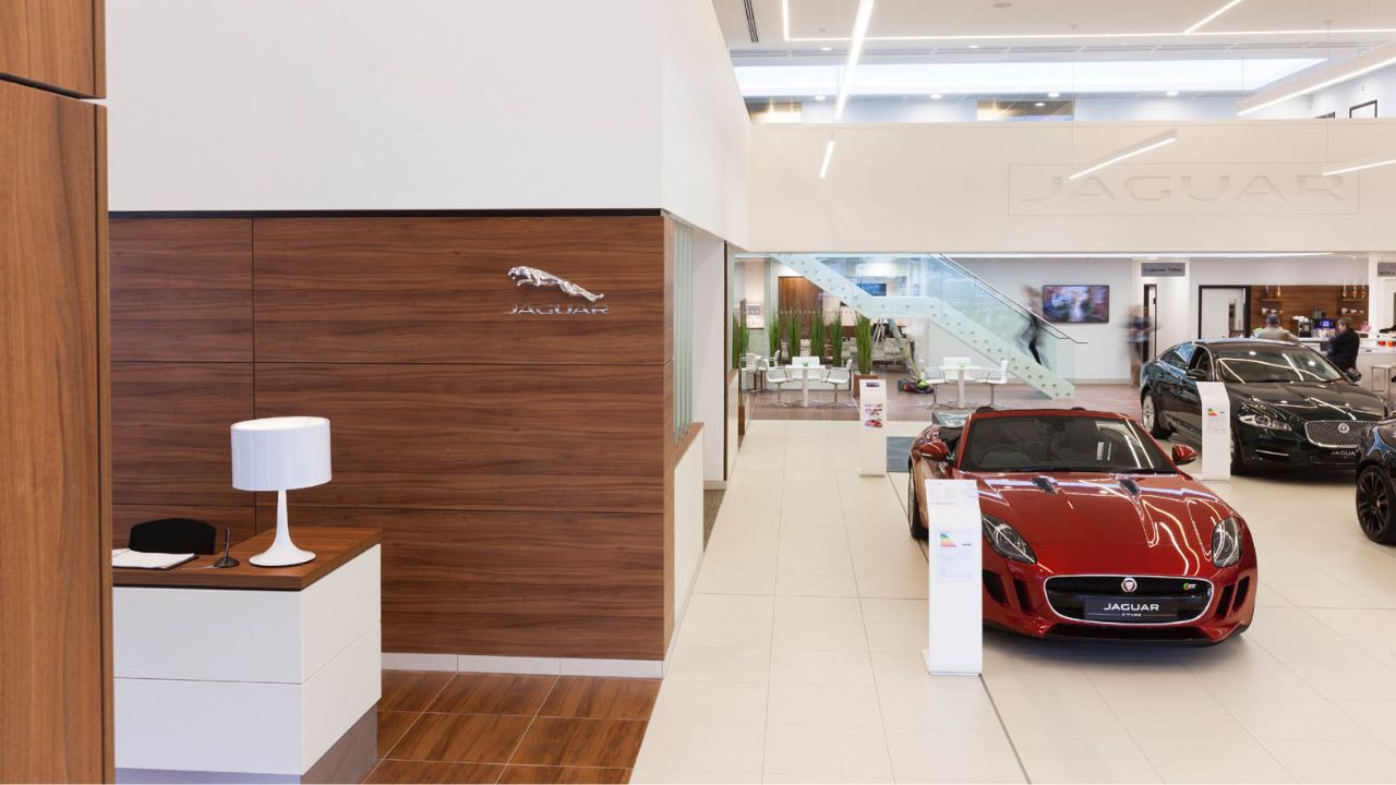 Jaguar dealership with a red Jaguar parked in the showroom