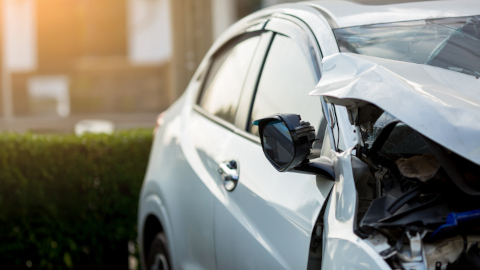 Half Of Silver Car Showing Damaged Bonnet and Wing Mirror