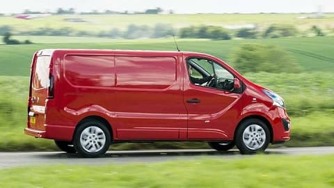 Red Vauxhall Vivaro, side shot, driving in the countryside