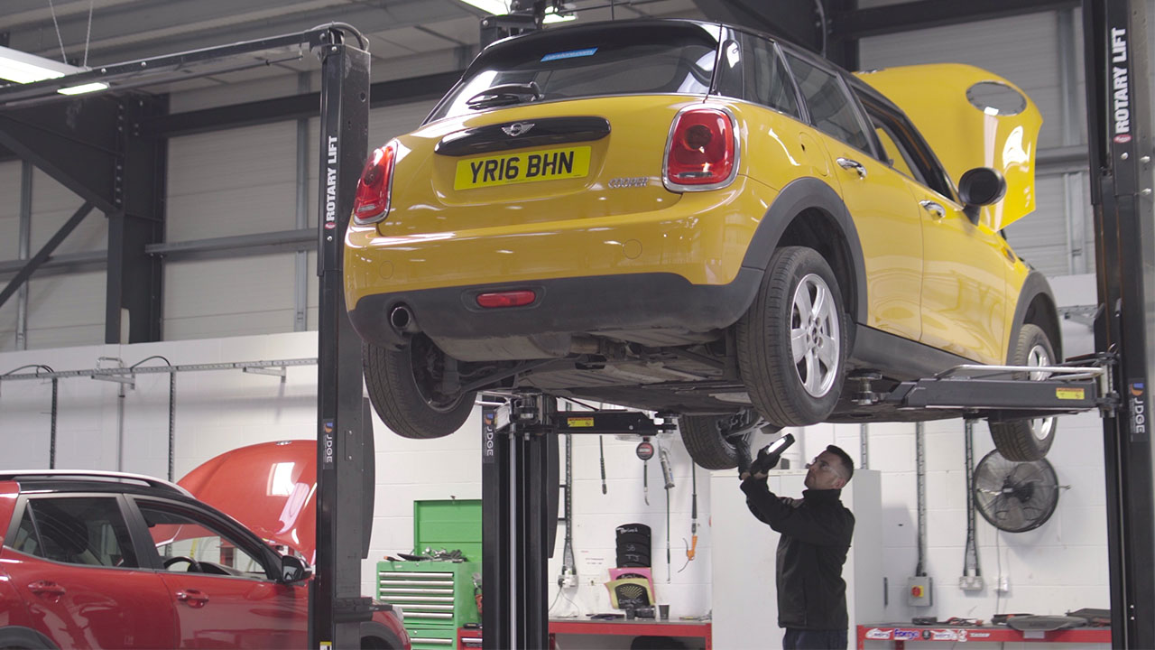 MOT Technician inspecting the underside of a MINI Hatchback