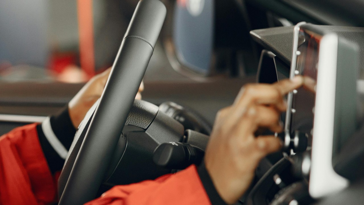 Hand touching car infotainment