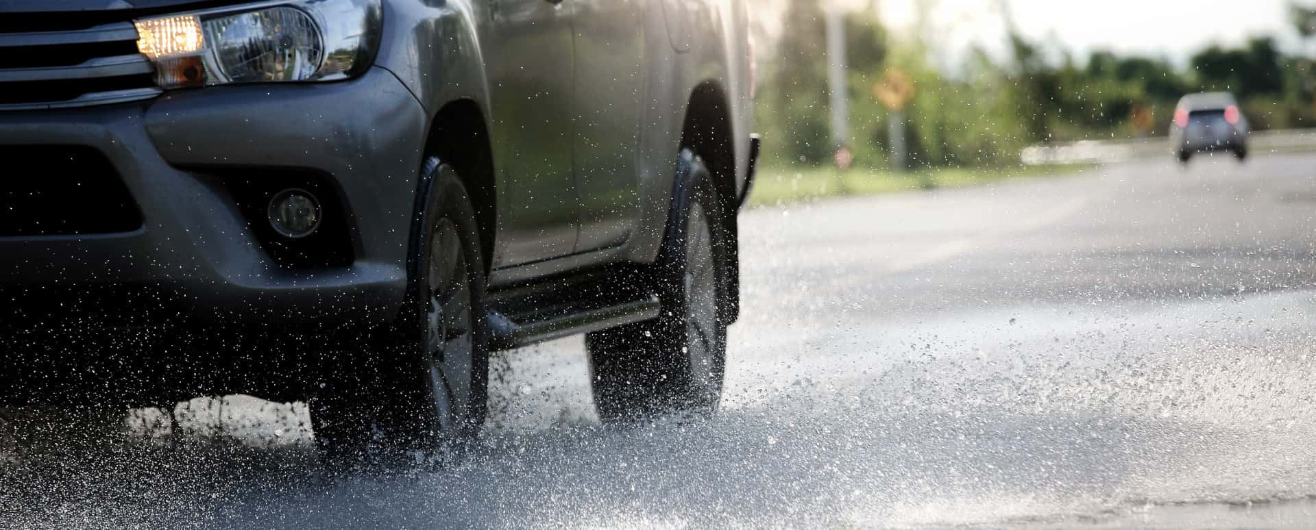 Car Driving Through Puddle